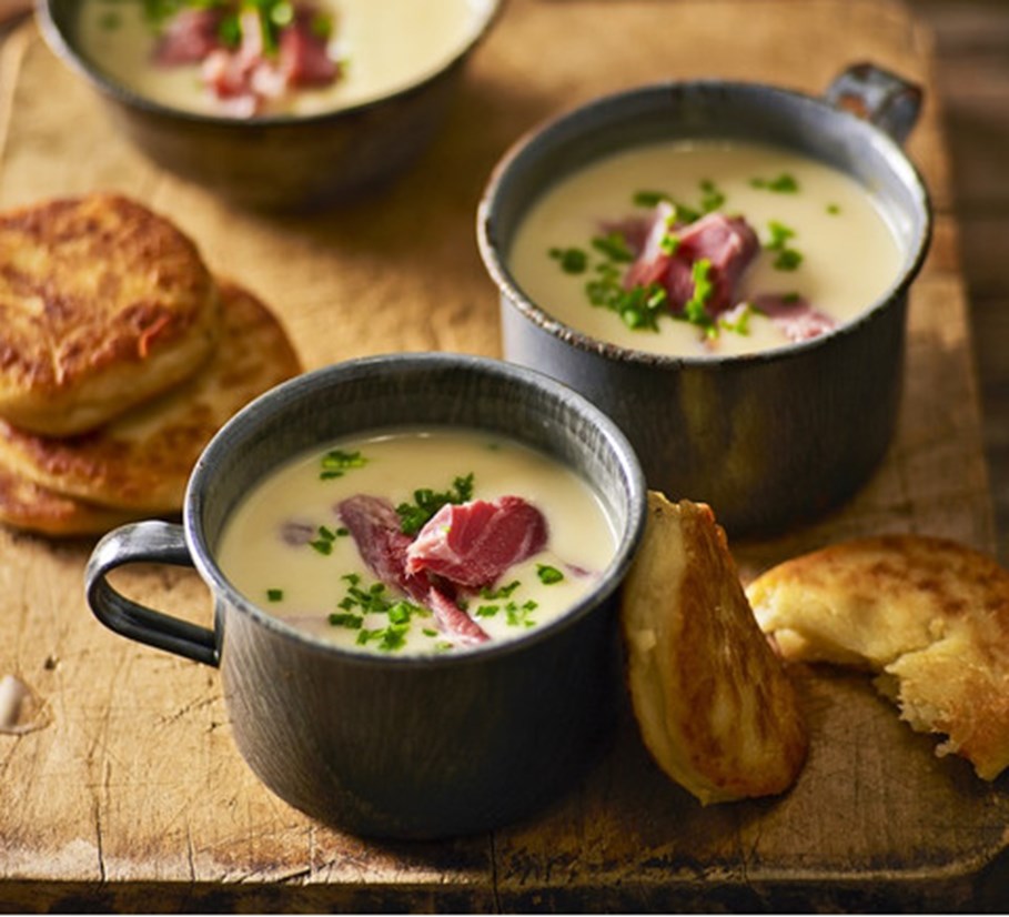 Mugs of Creamy Soup Garnished with Smoked Ham Hock